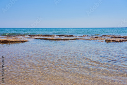 Stones on the shore of the warm tropical sea in Crete.