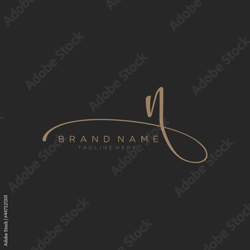Letter N gold handwritten logo vector design template. Black background. photo