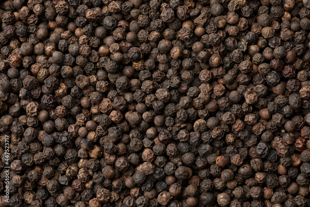 Dried black peppercorns close up full frame as a background Dried black peppercorns close up full frame as a background