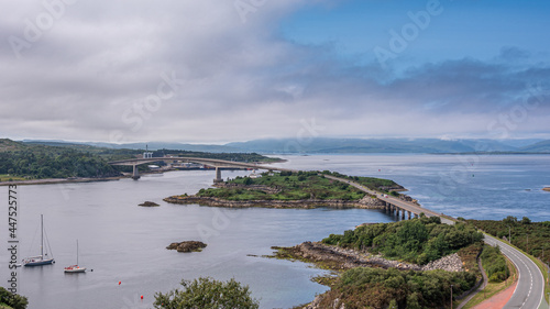 The Skye Bridge is a road bridge over Loch Alsh, Scotland, connecting the Isle of Skye to the island of Eilean Bàn and onto the mainland. Kyleakin Lighthouse can also be seen on the island photo