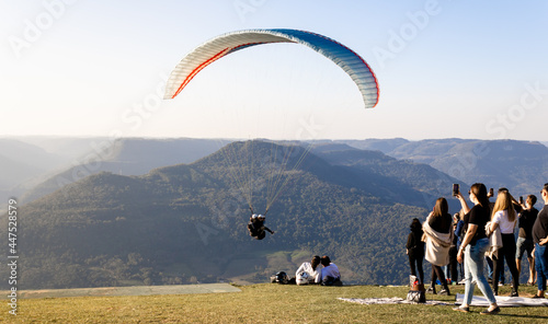 View from a paraglider in the Ninho das Águias mountain range in Nova Petrópolis with people watching and recording the takeoff moment. Place used for panoramic flights with incredible natural beauty.