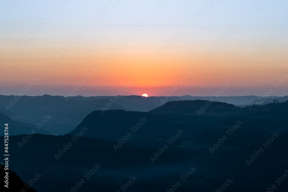 View of a sunset in the Ninho das Águias mountain range in Nova Petrópolis. Detail for colors in shades of orange. Place used for paragliding and paramotor flights with incredible natural beauty.