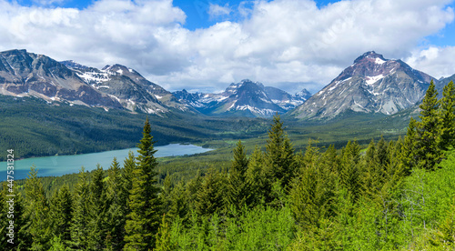Spring at Two Medicine Valley - A panoramic overview of Lower Two Medicine Lake surrounded by rugged high mountain peaks on a sunny Spring morning in Glacier National Park, Montana, USA. photo