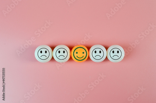 table tennis ball with sad and happy sad emotion. Customer evaluation and satisfaction concept.