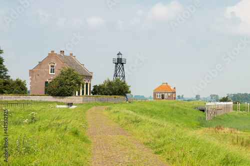 Lightkeepers House, lighthouse and a small foghorn house on the former island of Schokland in the Zuiderzee photo