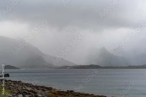 mystical fjord and Atlantic ocean on a cloudy and foggy summer day in the Lofoten Islands of northern Norway