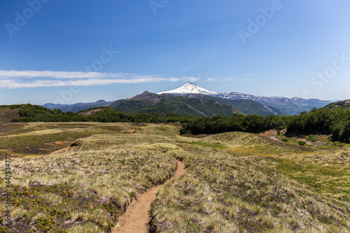 Villarrica Traverse Hiking trail in Catripulli with the snow-covered Villarica Volcano at the background, Araucanía, Chile photo