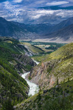 picturesque view of pure rapid river flowing among mountains at summer day 