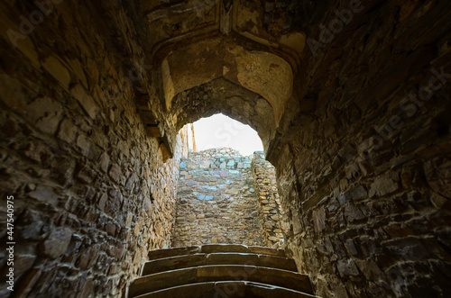 Narrow passage in the stone walls of Bhangarh Fort in Rajasthan, India photo