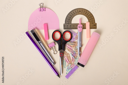 beautiful flat layout of school supplies. Scissors, pink marker, ruler, colored pencils, paper clips. Beautiful layout of stationery. High quality photo