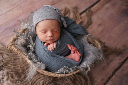 Sleeping newborn boy in the first days of life. Newborn photo session.