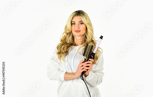 Useful Curling Iron Tricks Everyone Should Know. Create hairstyle with curling iron. Woman with long curly hair use curling iron. Hairdresser tips. Girl adorable blonde. Buy tools. Online shop