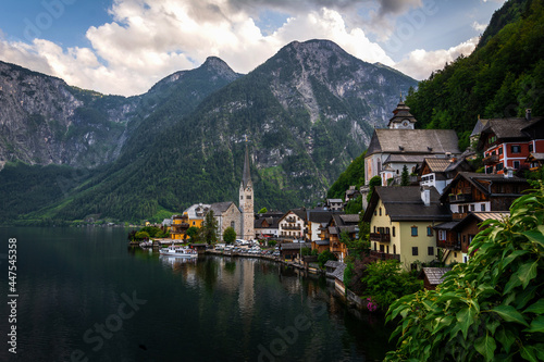 Scenic panoramic view of famous Hallstatt lakeside town reflecting in Hallstattersee lake in the Austrian Alps in scenic morning light on a beautiful sunny day in summer, Salzkammergut region, Austria © Denis Poltoradnev