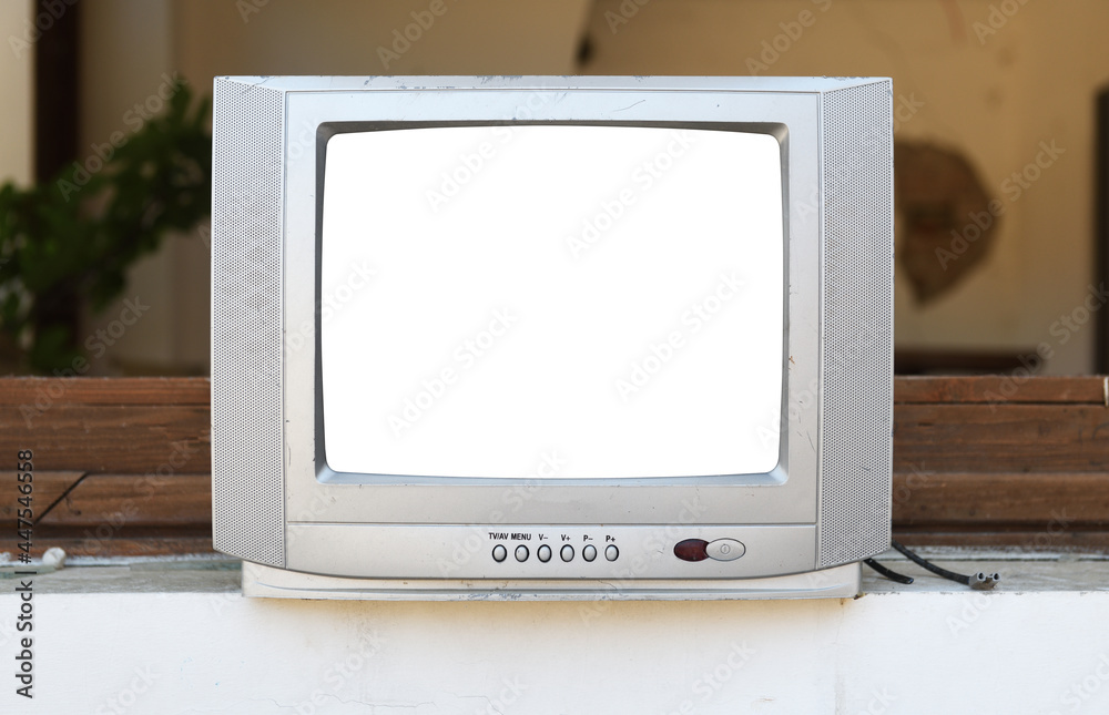 Old silver TV with white isolated screen near an abandoned hotel. Vintage TVs 1980s 1990s 2000s. 