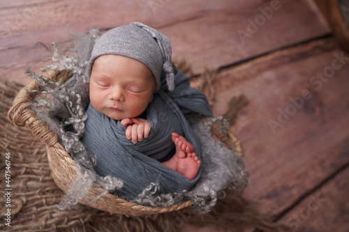 Sleeping newborn boy in the first days of life. Newborn photo session.