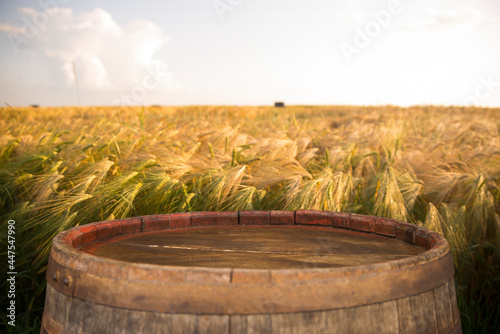 wooden board table in front of wheat field on sunset light. Ready for product display montages © kishivan