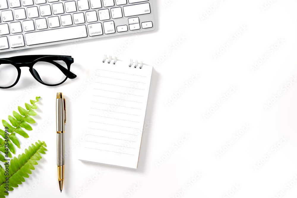 white Office Desk with Computer Notepad pen Green leaf and other Supplies. Blank Paper sheet on right for input the text, Top View, Flat Lay. white Office Desk with Computer Notepad pen Green leaf and other Supplies. Blank Paper sheet on right for input the text, Top View, Flat Lay.