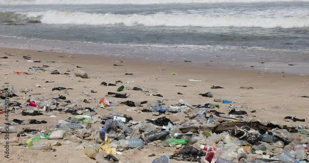 Surf Trash Pollution sandy beach Accra Ghana Africa. Atlantic ocean. Beaches polluted by trash, garbage and sewage. Summer vacation destination. Plastic industrial waste health issue. Surf Trash Pollution sandy beach Accra Ghana Africa. Atlantic ocean. Beaches polluted by trash, garbage and sewage. Summer vacation destination. Plastic industrial waste health issue.