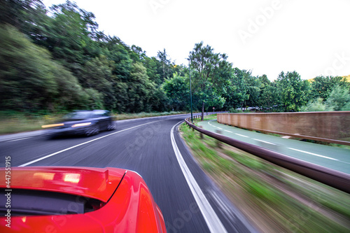 Red car driving on highway