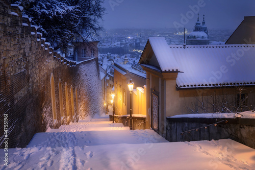Fotografie Stairs leading to the Prague Castle covered with snow.