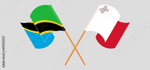 Crossed and waving flags of Tanzania and Malta