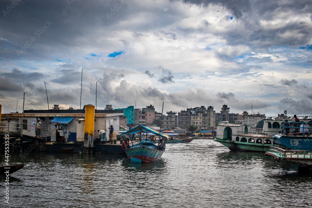 Traditional boat station under the cloudy sky. This image has been captured on August-18-2020 by me, from the Burigongga river, Bangladesh, South Asia