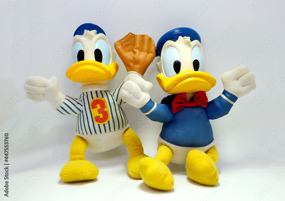 Donald Duck dressed as a baseball player and in his classic sailor suit. Cartoon character from Walt Disney Pictures Studios. Toys for children. Mickey Mouse's friend. Daisy Duck's boyfriend. Stock Photo | Donald Duck dressed as a baseball player and in his classic sailor suit. Cartoon character from Walt Disney Pictures Studios. Toys for children. Mickey Mouse's friend. Daisy Duck's boyfriend. Stock Photo |