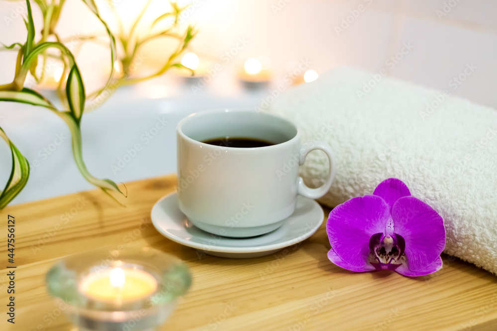 Spa-beauty salon, wellness center. Aromatherapy spa treatment for the female body in the bathroom with a cup of coffee, candles, oils and salt. Spa-beauty salon, wellness center. Aromatherapy spa treatment for the female body in the bathroom with a cup of coffee, candles, oils and salt.