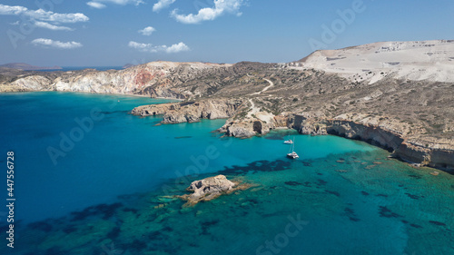 Aerial drone photo of beautiful volcanic emerald paradise bay and sandy beach of Tsigrado below white rock with perlite mine, Milos island, Cyclades, Greece © aerial-drone