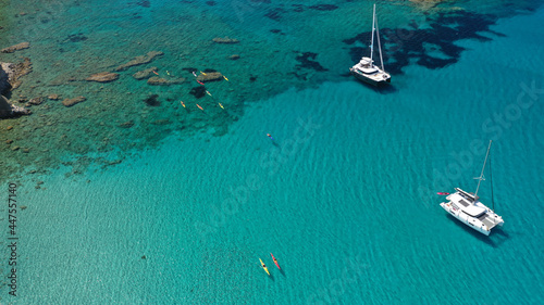 Aerial drone photo of catamaran sailing yacht anchored in tropical exotic emerald sea coral reef bay