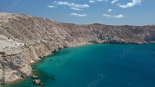 Aerial drone photo of secluded paradise sandy beach of Kalamos mostly covered by perlite rock only accessible by boat, Milos island, Cyclades, Greece