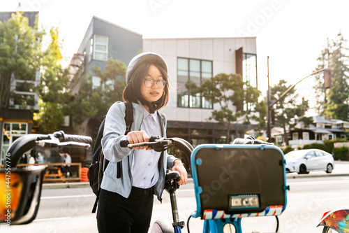 Young professional using bike share in urban setting photo