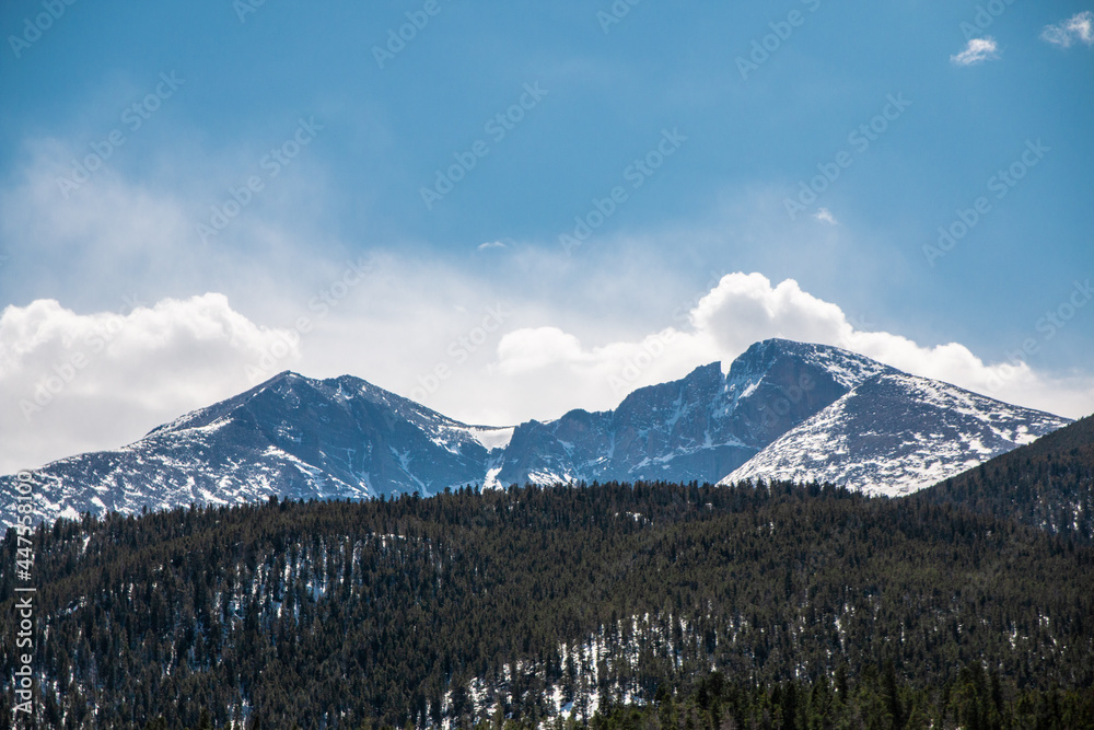 Beautiful Snowy Mountains Surrounded by Clouds on a Clear Day