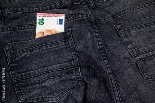 10 euros coming out of the jeans pocket