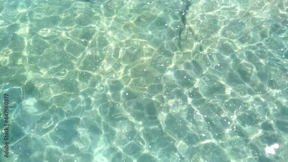 Top view natural background of rippled sea-green sea water. Aerial view of aquamarine sea surface. Rough sea texture. Marine theme with copy space. Top view natural background of rippled sea-green sea water. Aerial view of aquamarine sea surface. Rough sea texture. Marine theme with copy space.