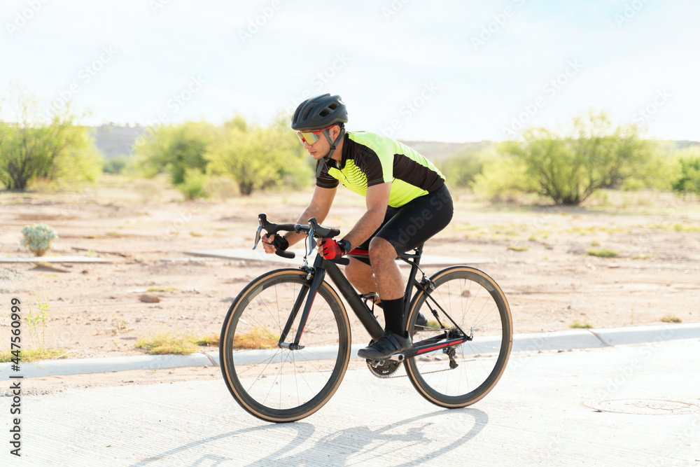 Side view of a handsome cyclist training Side view of a handsome cyclist training