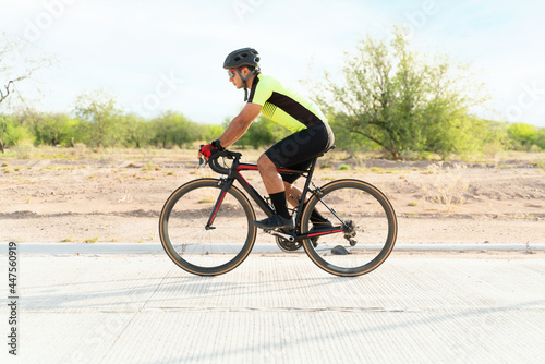 Sporty athlete riding a road bike outdoors