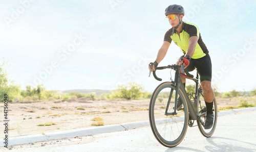 Fototapeta Naklejka Na Ścianę i Meble -  Attractive young man focused on cycling