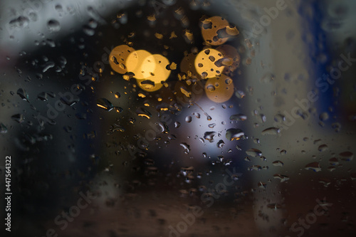 raindrops and jets on glass of car. rainy weather. background in blur.
