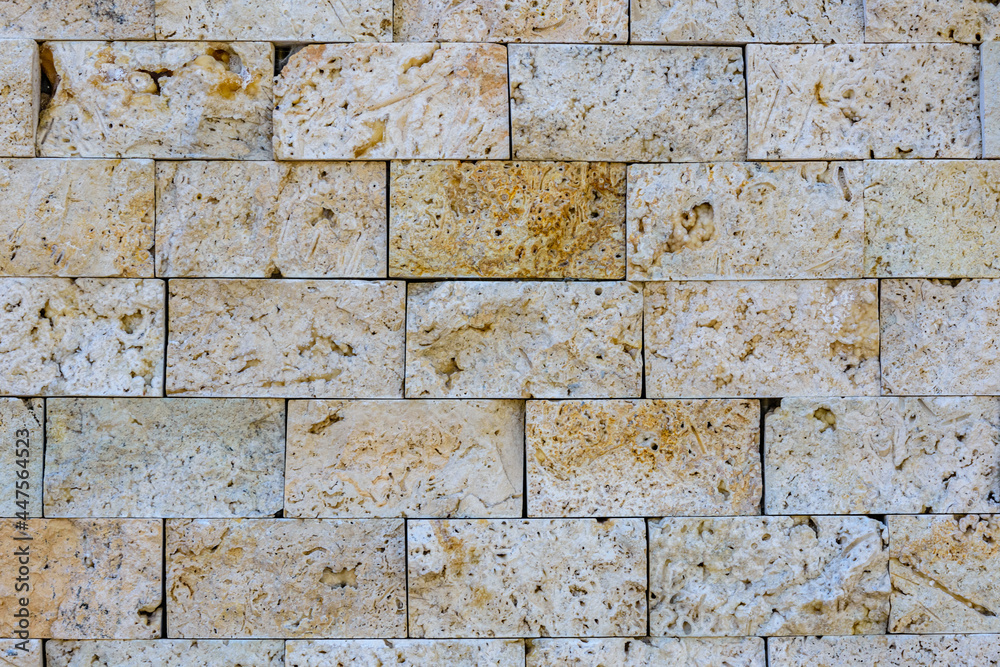 Fototapeta premium Texture of the limestone bricks for background. Natural pattern