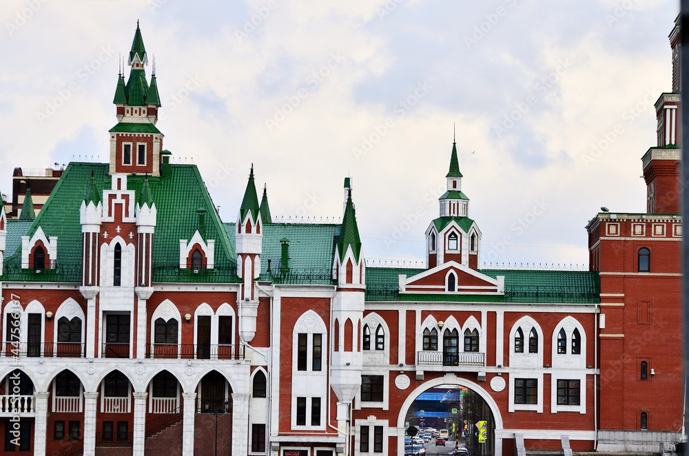 Obraz premium The building is in the Dutch style of red and white brick with a green roof. Russia Yoshkar Ola 01.05.2021. High quality photo
