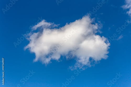 large textured cumulus cloud against blue summer sky as a natural background