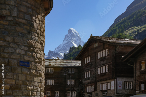 View of iconic Matterhorn from Zermatt with tipical houses and trails, Valais, Swiss Alps, Switzerland © Miguel