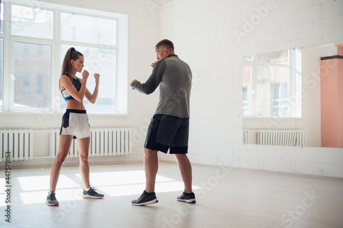 Female MMA fighter training punches technique © romankosolapov