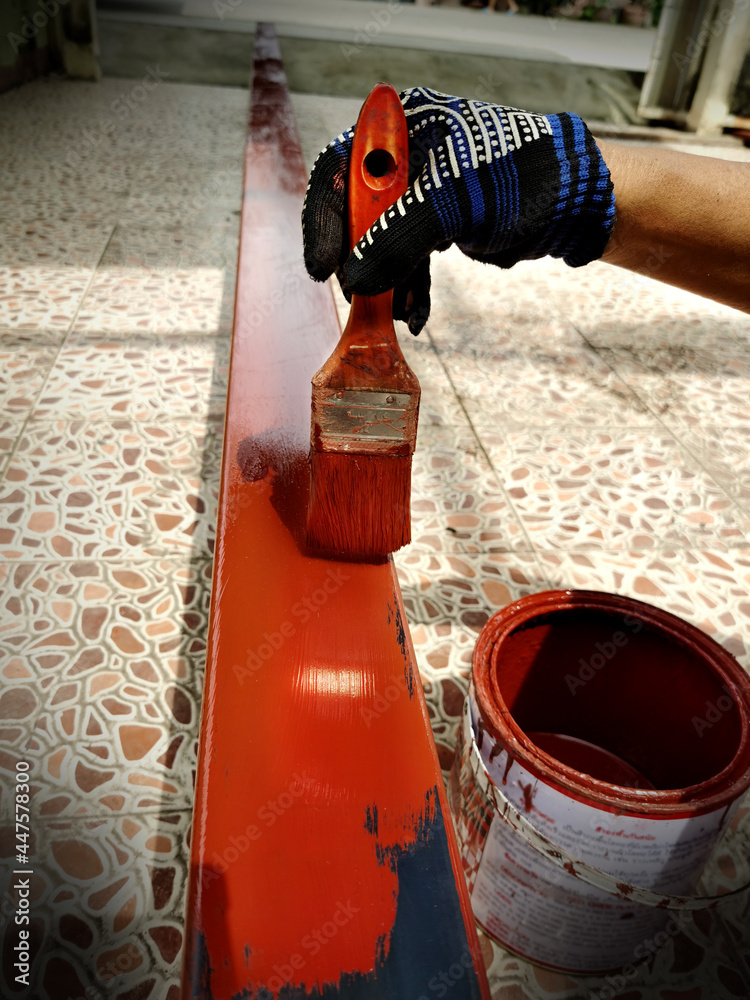 Red paint brush for applying rust-proof steel. was painting a long iron on the floor