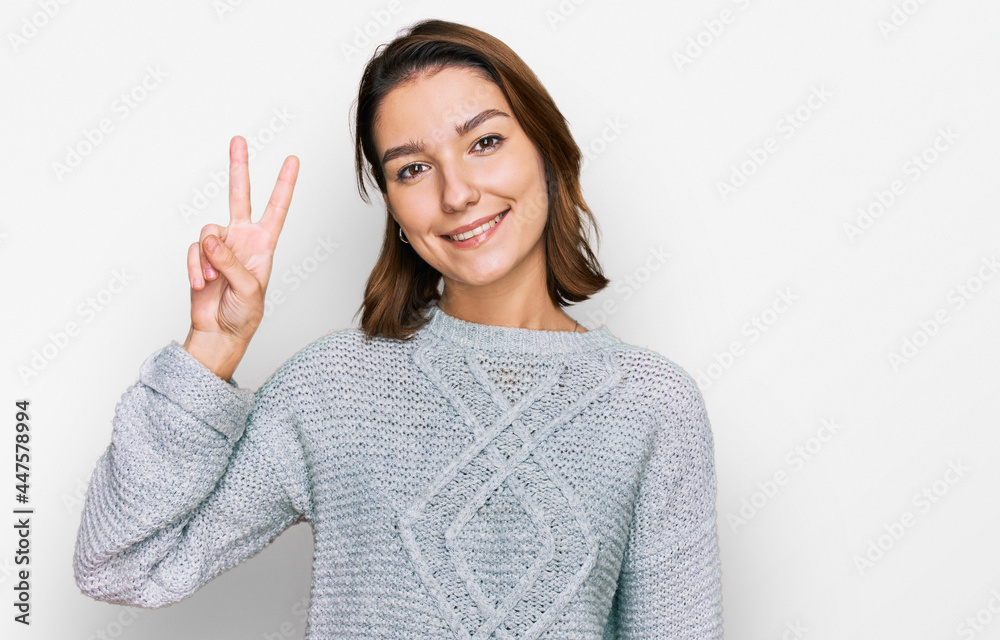 Young caucasian girl wearing casual clothes showing and pointing up with fingers number two while smiling confident and happy. Young caucasian girl wearing casual clothes showing and pointing up with fingers number two while smiling confident and happy.