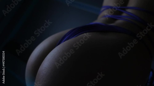 pumped sexy forms of a girl in a swimsuit from behind