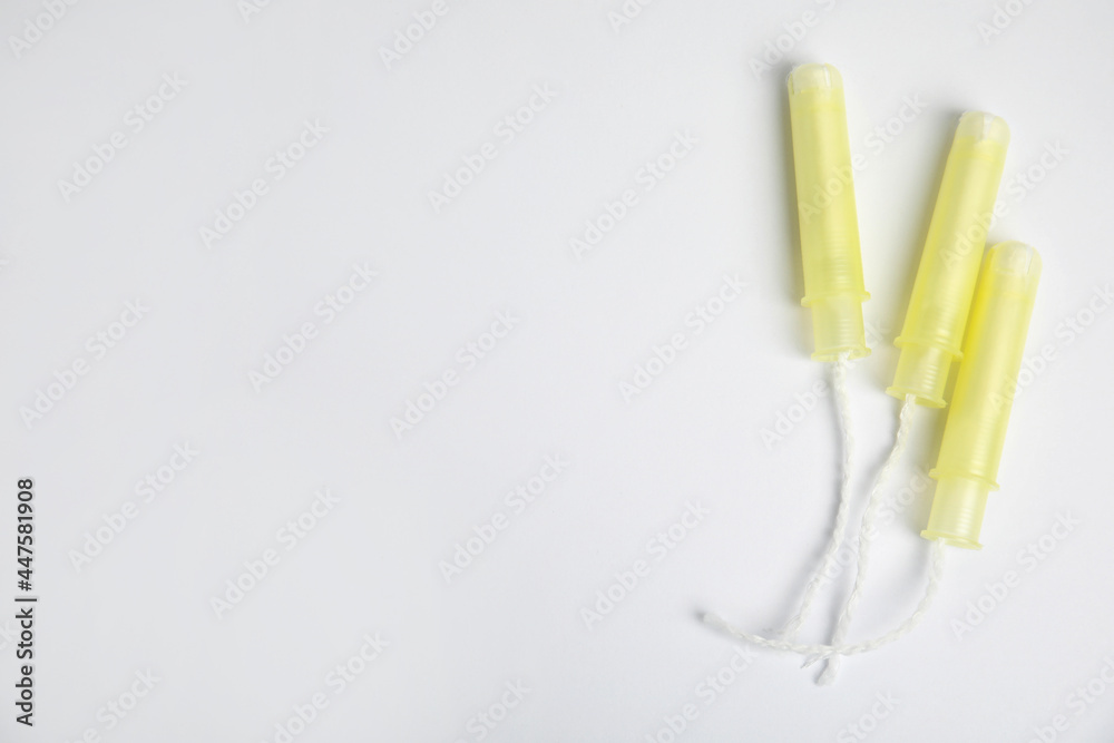 Tampons on light background, flat lay. Space for text Tampons on light background, flat lay. Space for text