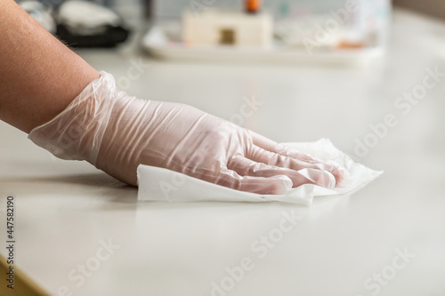 Wallpaper Mural A person disinfecting a table Torontodigital.ca