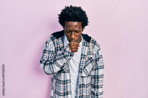 Young african american man wearing casual clothes feeling unwell and coughing as symptom for cold or bronchitis. health care concept. © Krakenimages.com